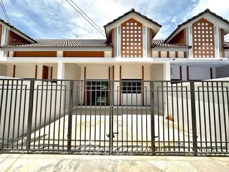 Charming modern townhouse with gated entrance and unique architectural design.