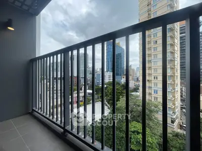 Stunning cityscape view from a modern balcony in a high-rise building.