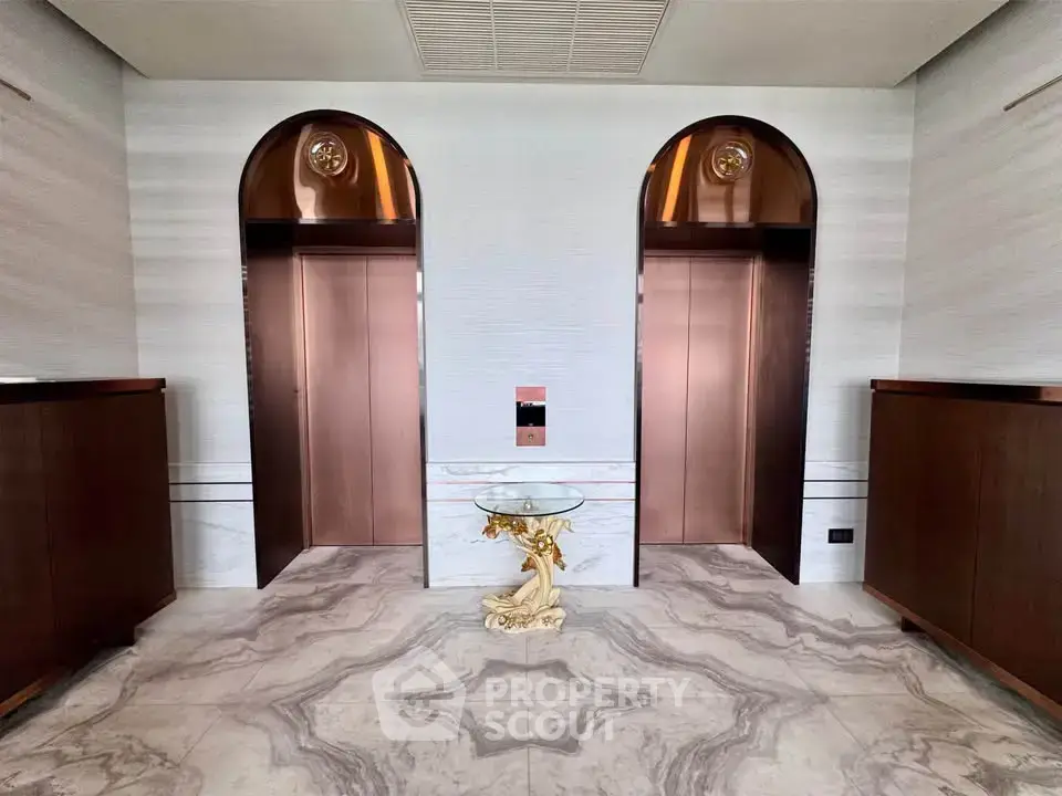 Luxurious building lobby with elegant elevators and marble flooring