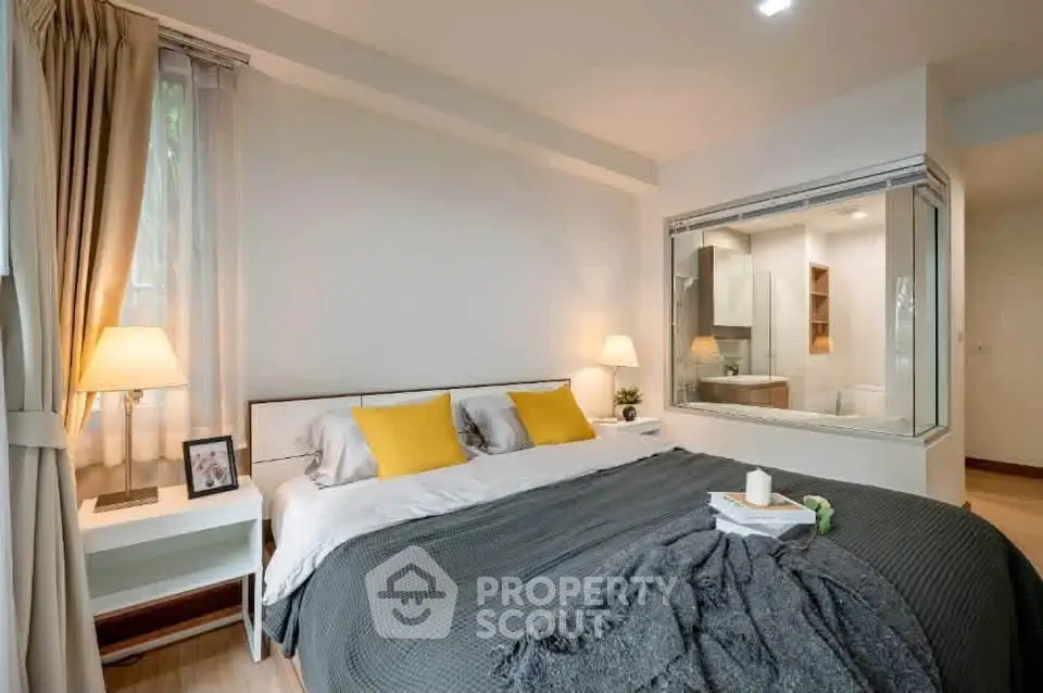 Spacious modern bedroom with large window and cozy decor