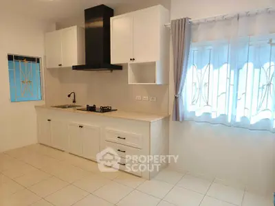 Modern kitchen with white cabinets and gas stove in bright interior