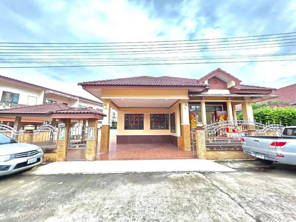 Charming suburban house with spacious driveway and tiled roof, perfect for family living.
