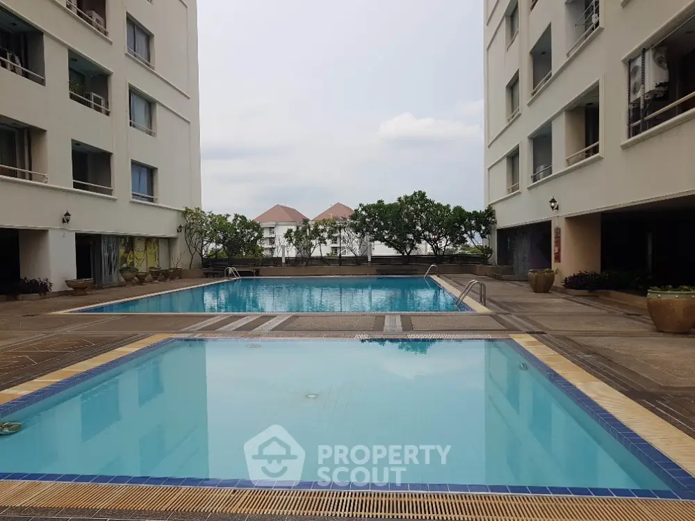 Luxurious residential complex with stunning swimming pool and serene surroundings