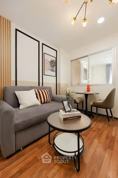 Stylish modern living room with cozy sofa and elegant dining area, perfect for urban living.
