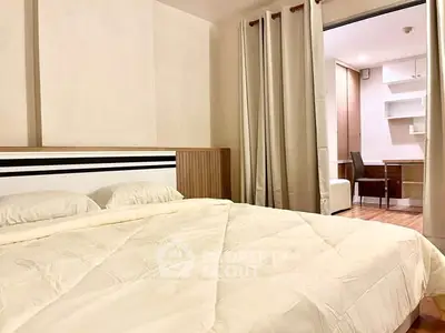 Cozy bedroom with modern decor and adjacent study area, perfect for relaxation and productivity.