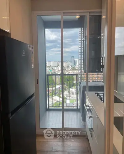 Modern kitchen with balcony view in high-rise apartment