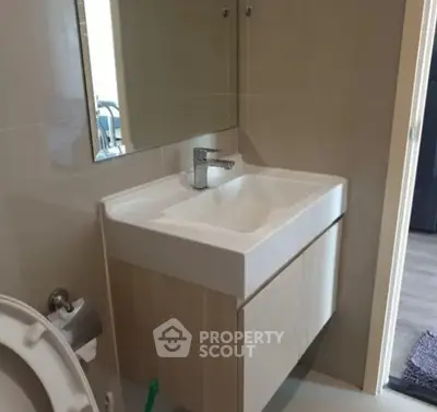 Modern bathroom with sleek sink and mirror in a stylish home.