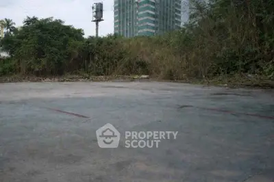 Vacant land plot with urban backdrop, ideal for development opportunities.