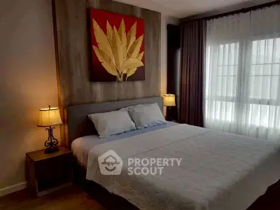Elegant bedroom with stylish decor and natural light, featuring a comfortable bed and modern furnishings.