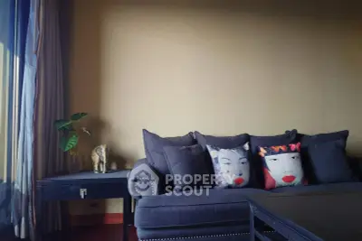 Stylish living room with elegant sofa and artistic cushions