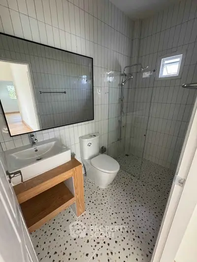 Modern bathroom with glass shower and stylish tile flooring
