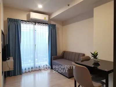 Modern living room with sofa, dining table, and air conditioning in cozy apartment.