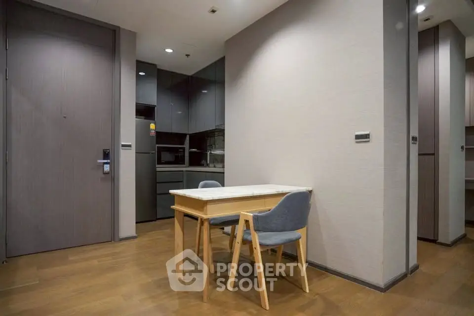Modern dining area with sleek wooden flooring and compact table set