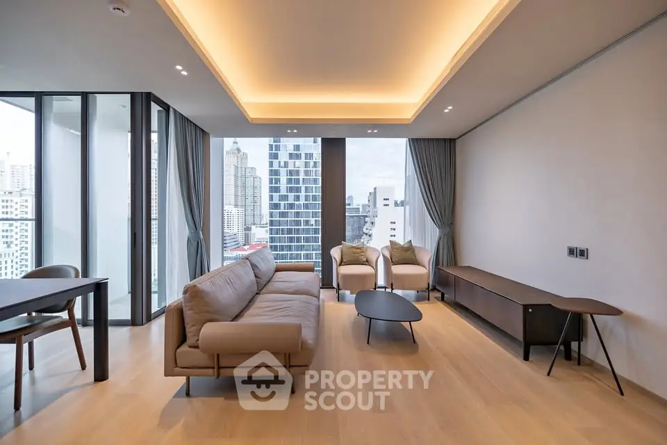 Modern living room with city view, featuring sleek furniture and floor-to-ceiling windows.
