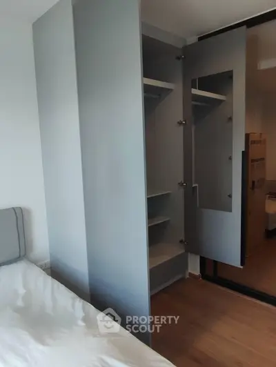 Modern bedroom with sleek built-in wardrobe and cozy bed setup