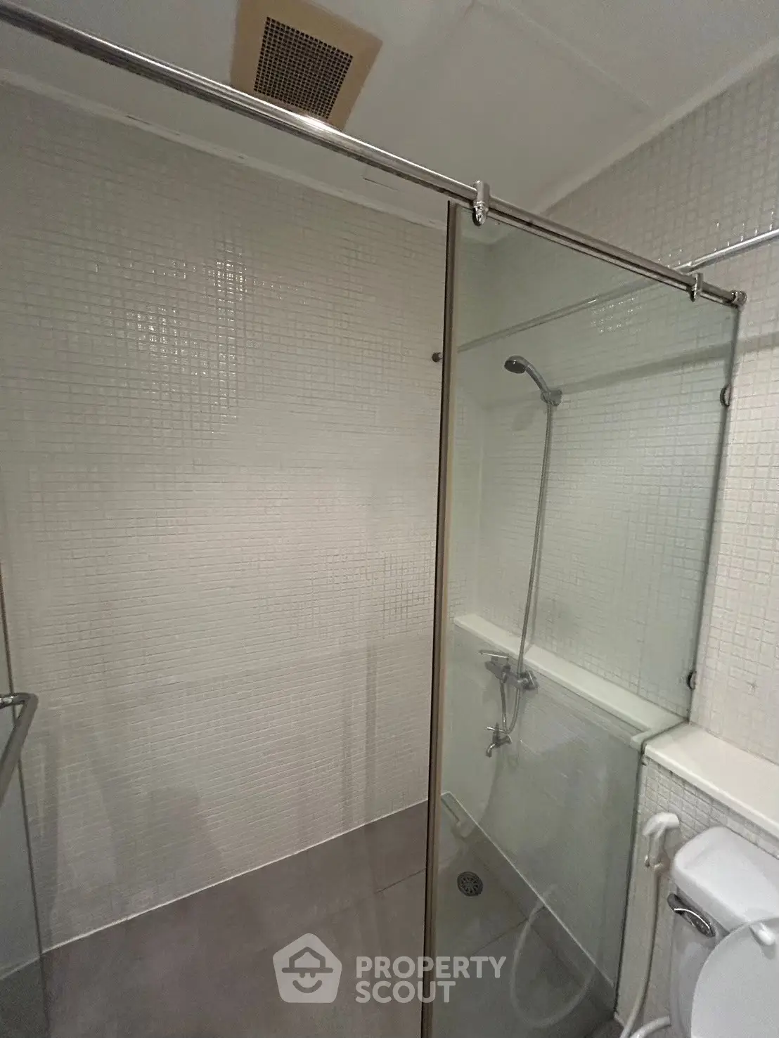 Modern bathroom with glass shower enclosure and sleek tile design