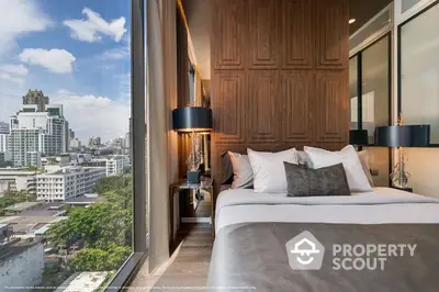 Luxurious bedroom with floor-to-ceiling windows offering an expansive city view, modern furnishings, and a serene ambiance.