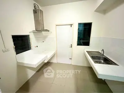 Modern kitchen with sleek countertops and stainless steel sink