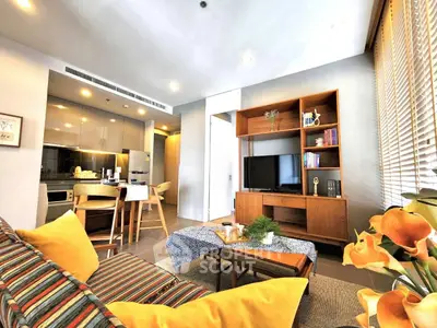 Modern living room with stylish decor and open kitchen layout in a cozy apartment.