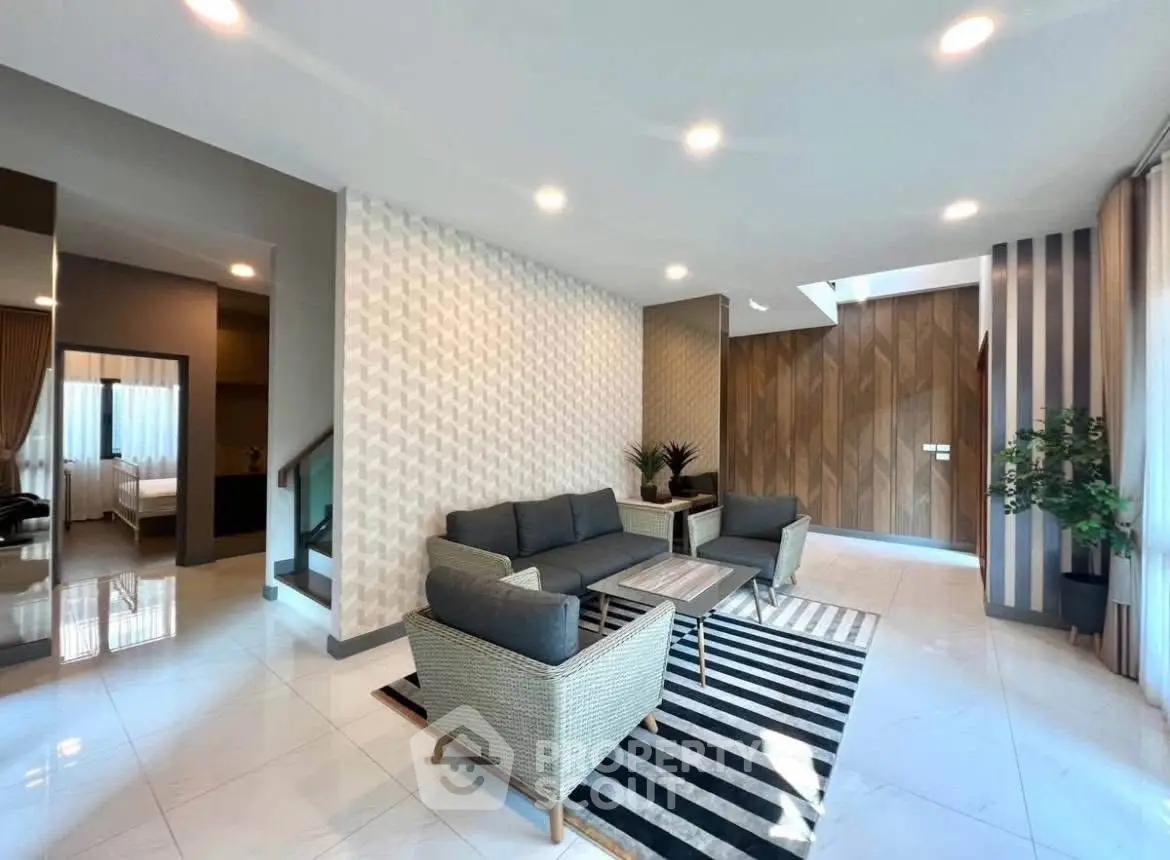 Spacious modern living room with stylish decor and ample natural light