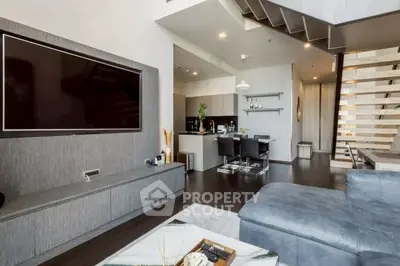 Modern living room with sleek design and open kitchen layout