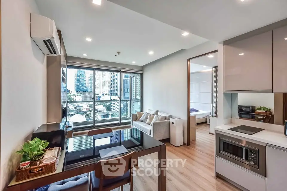 Modern open-plan living room with city view, sleek kitchen, and cozy bedroom in urban apartment.