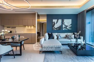 Luxurious modern living room with open kitchen, elegant decor, and large windows for natural light.