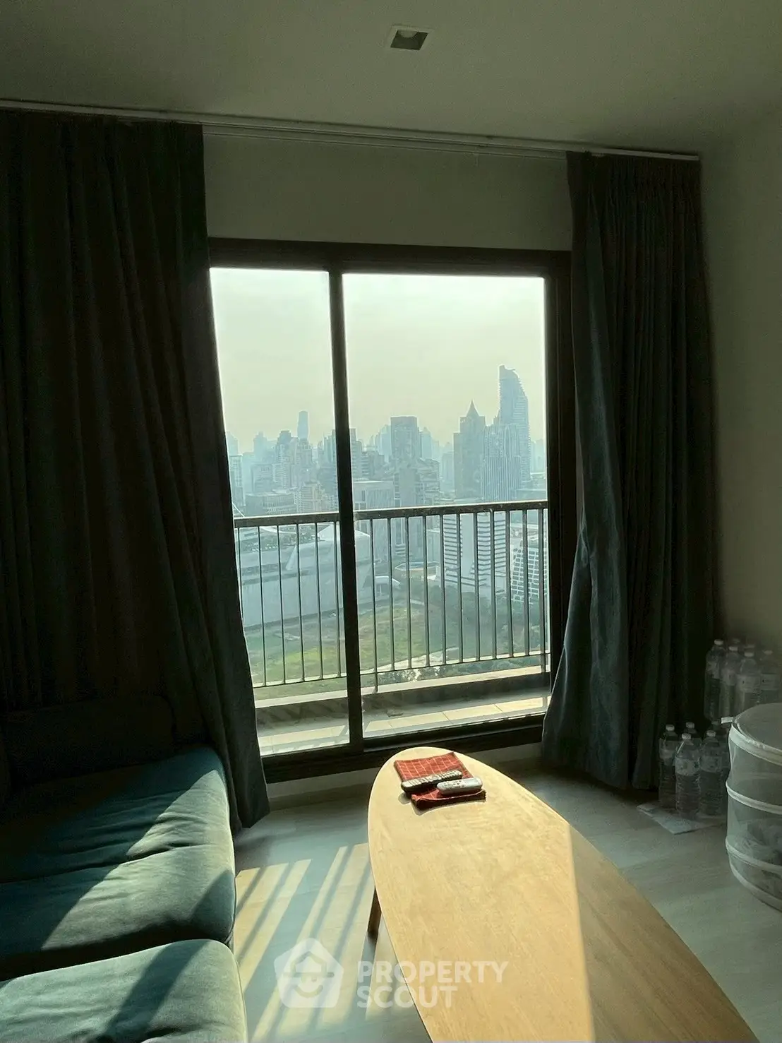 Stunning high-rise living room with panoramic city view and cozy seating area.