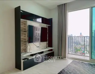 Modern living room with city view and sleek entertainment unit.