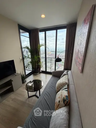 Modern living room with stunning city view, featuring sleek furniture and floor-to-ceiling windows.