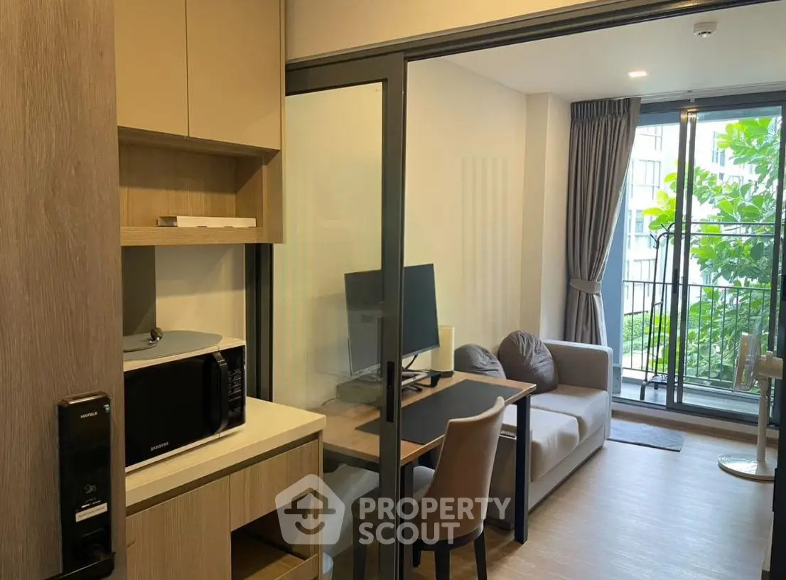 Modern studio apartment with cozy living area and balcony view