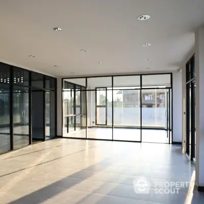 Spacious modern living room with large windows and abundant natural light