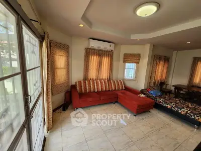 Spacious living room with red sectional sofa and natural light