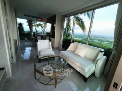 Luxurious living room with panoramic views and elegant furnishings in a modern high-rise apartment.