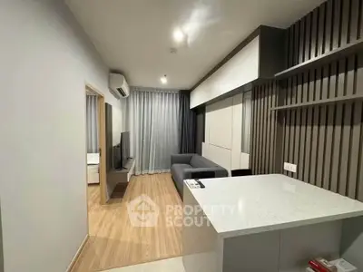 Modern living room with sleek design and open layout, featuring a cozy sofa and stylish decor.