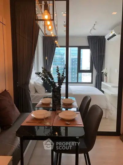 Modern apartment interior with dining area and cozy bedroom view