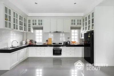 Modern kitchen with sleek cabinetry and built-in appliances in a spacious layout.