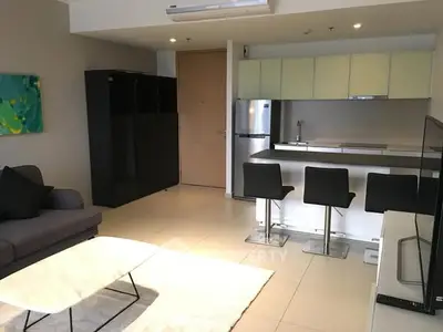 Modern open-plan living room with kitchen and stylish furniture