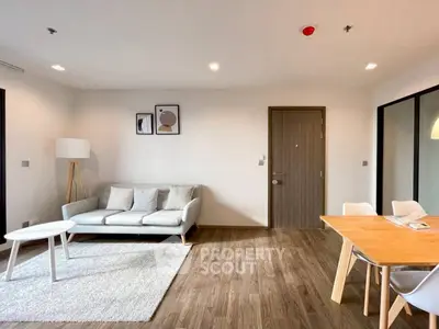 Modern living room with stylish furniture and wooden flooring