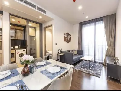 Modern open-plan living room with dining area and kitchen in stylish apartment