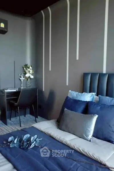Modern bedroom with stylish decor and cozy workspace