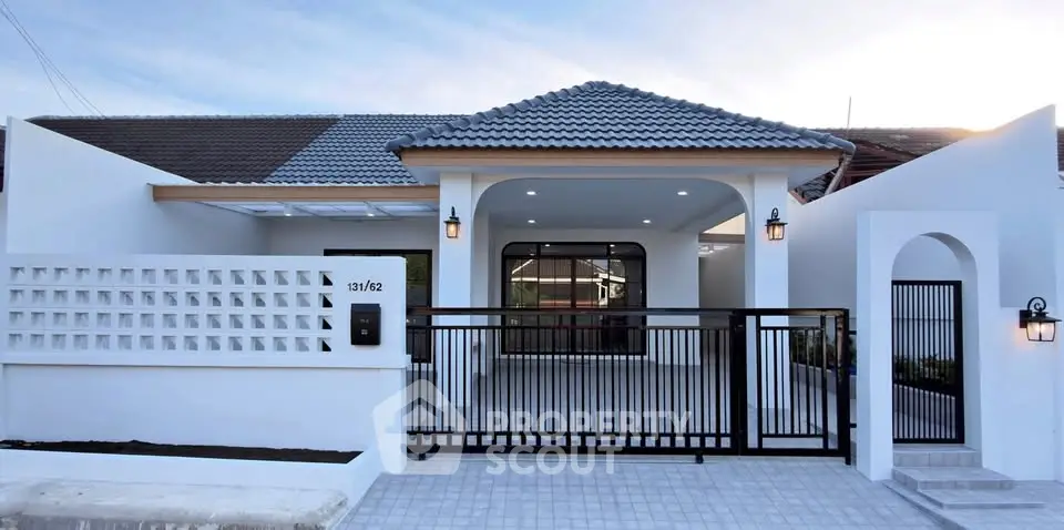 Charming modern house with tiled roof and gated entrance, perfect for family living.