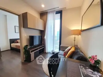 Modern living room with cozy sofa, TV, and bedroom view in stylish apartment.
