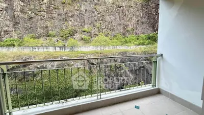 Spacious balcony with stunning natural rock view, perfect for relaxation and enjoying nature.