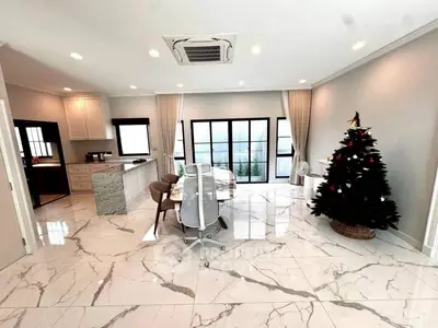 Spacious modern living room with marble flooring and Christmas tree