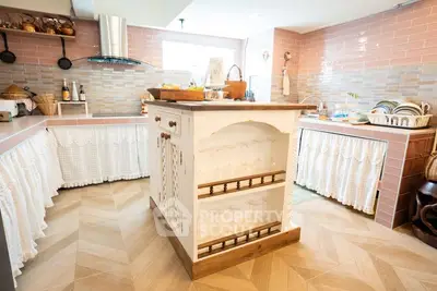 Charming rustic kitchen with island and open shelving, perfect for cozy home cooking.