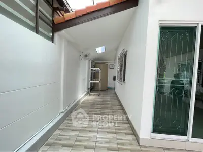Spacious tiled corridor with skylight and modern design