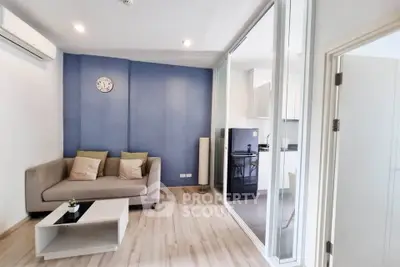 Modern living room with blue accent wall and cozy sofa in stylish apartment