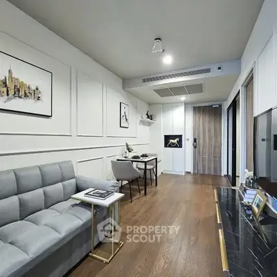 Modern living room with stylish decor and wooden flooring in a contemporary apartment.