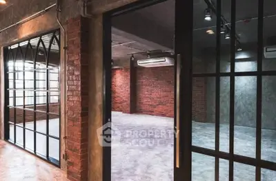 Spacious industrial-style loft with exposed brick and large windows